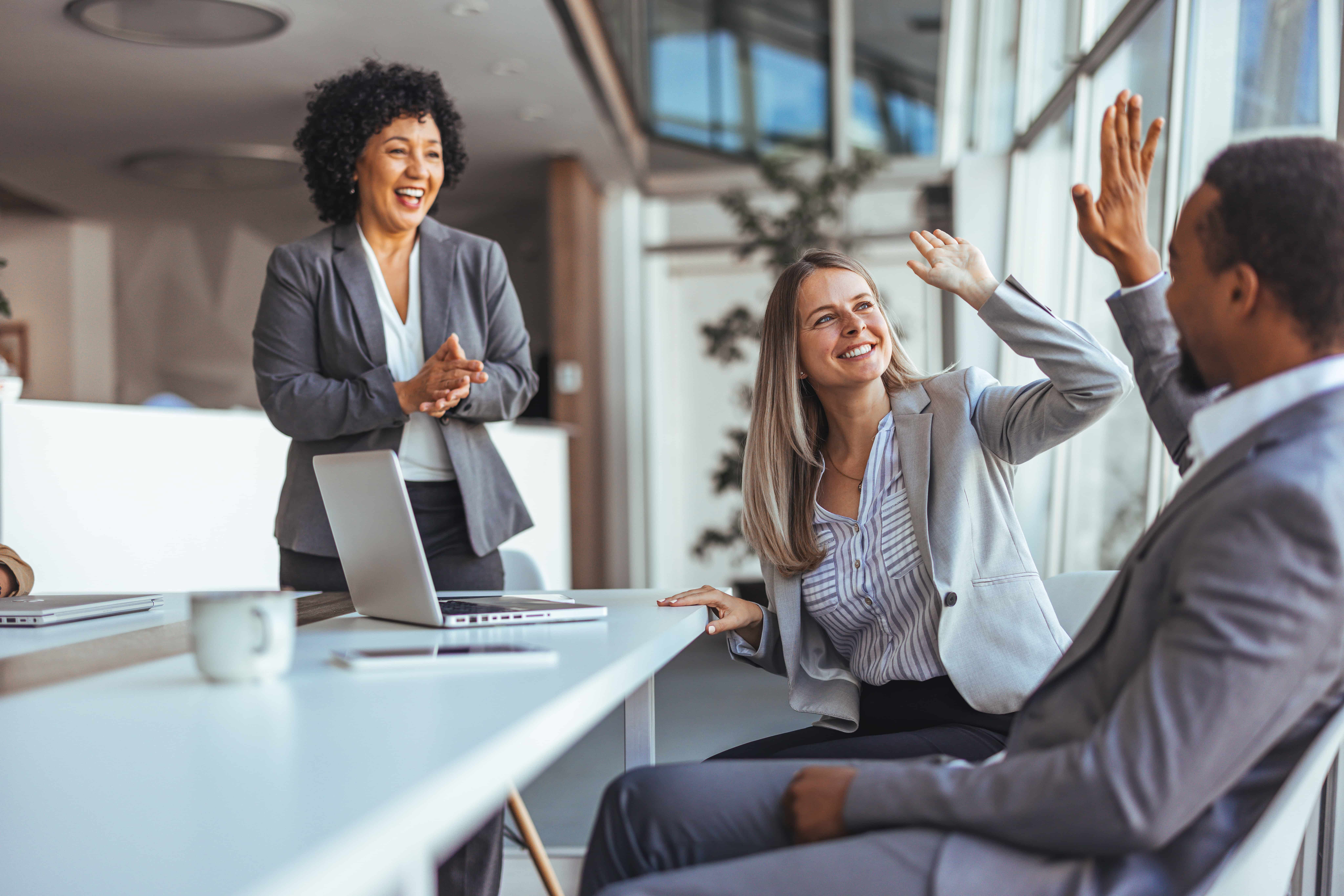 Productivity increase after incentive trip employees in a corporate office celebrating success